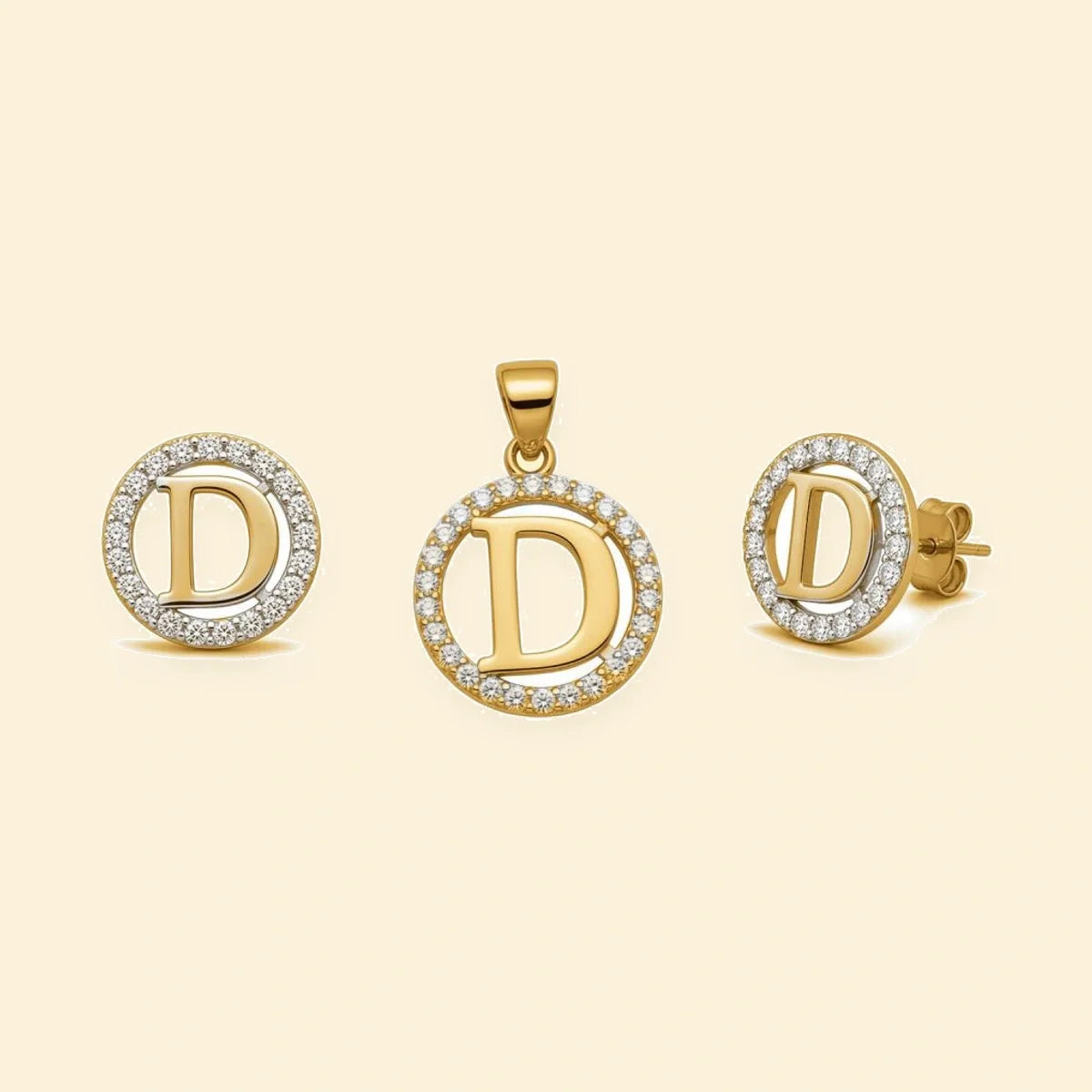 Gold plated sterling silver CZ initial D pendant set on ivory background