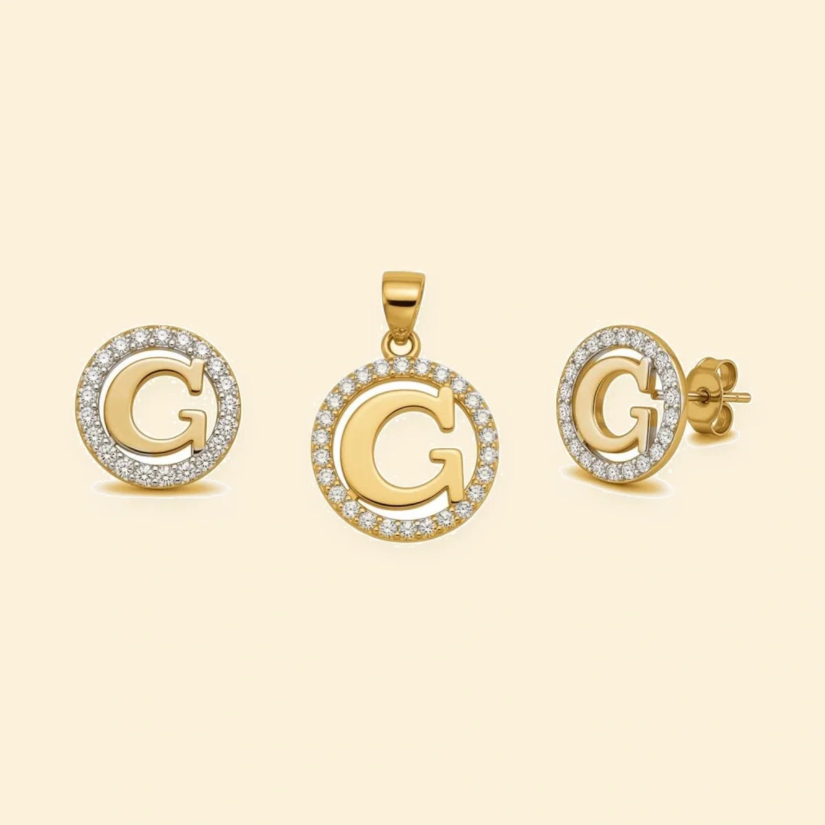 Gold plated sterling silver CZ initial G pendant set on ivory background