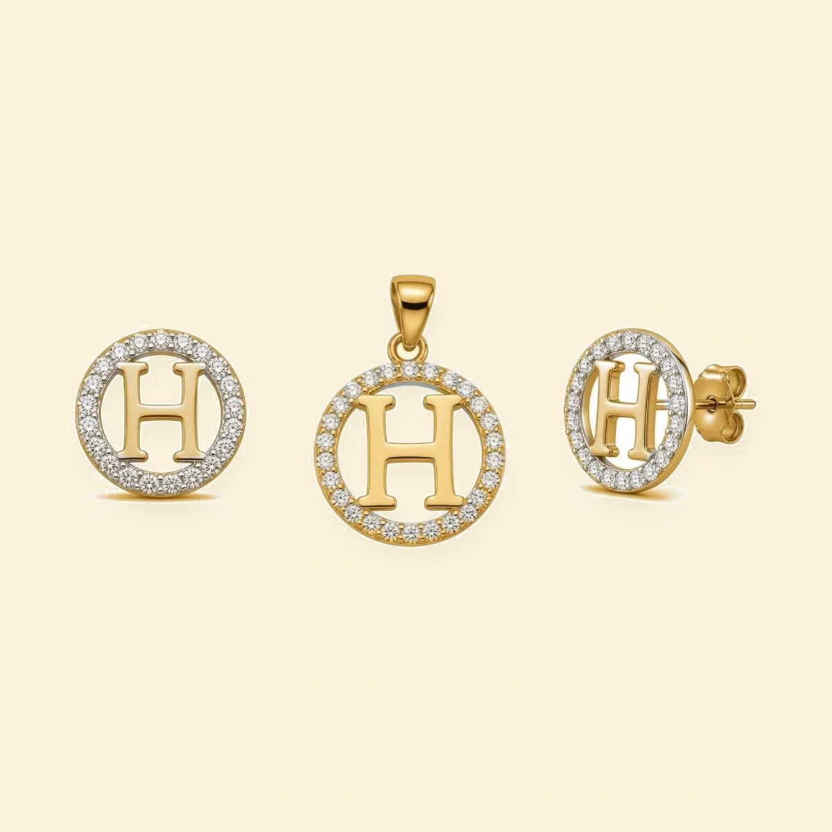 Gold plated sterling silver CZ initial H pendant set on ivory background