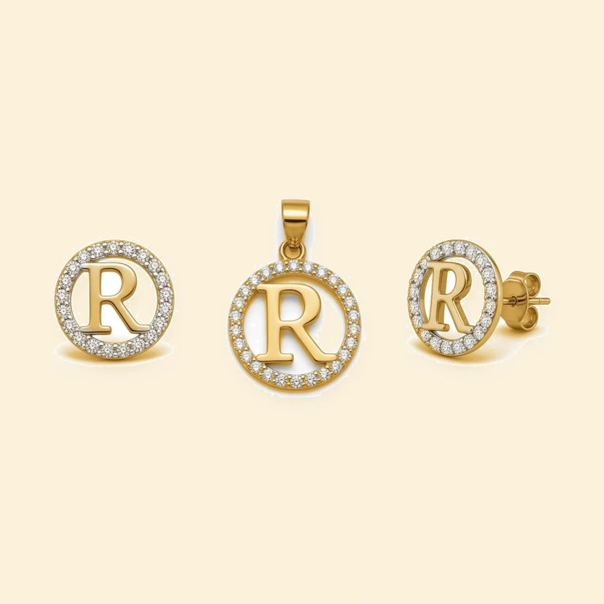 Gold plated sterling silver CZ initial R pendant set on ivory background