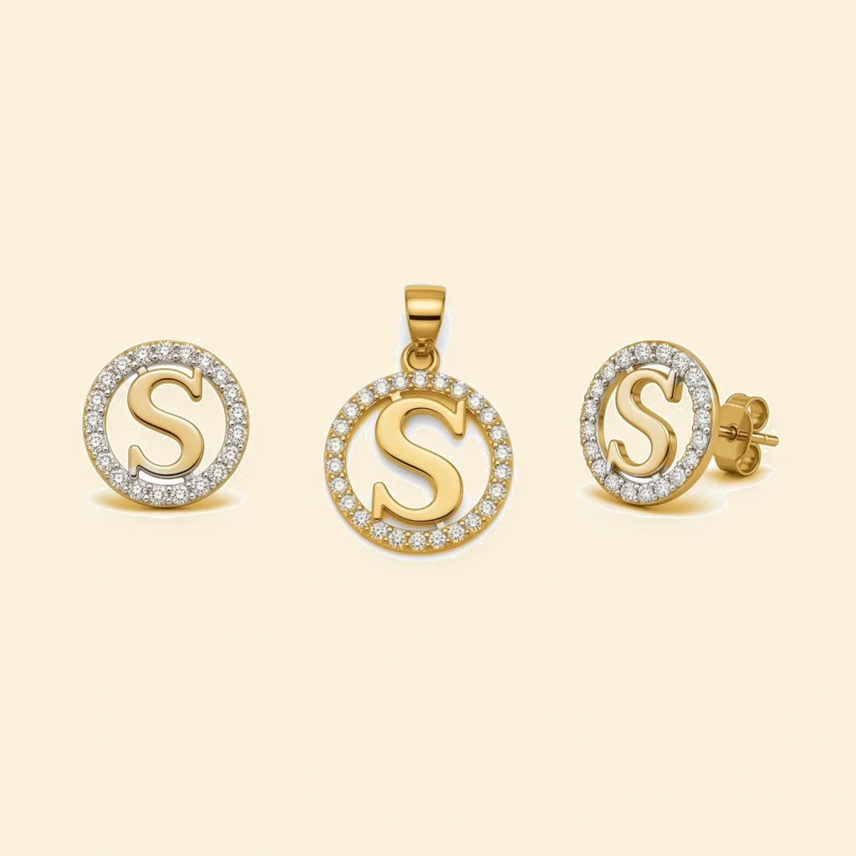 Gold plated sterling silver CZ initial S pendant set on ivory background