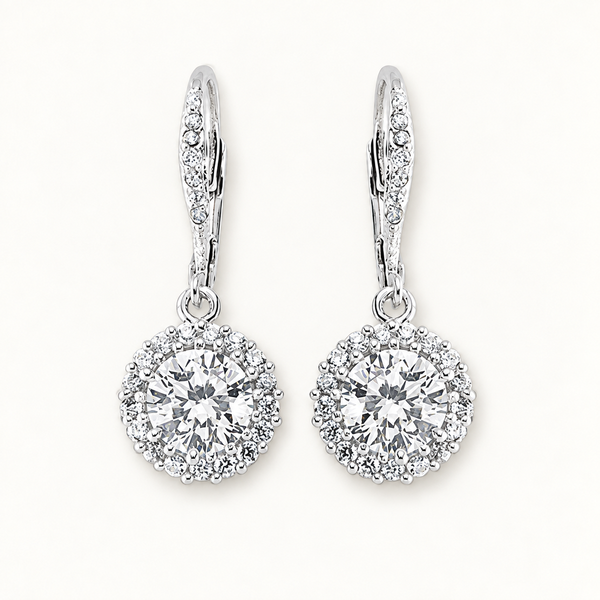 Silver CZ drop earrings on ivory background