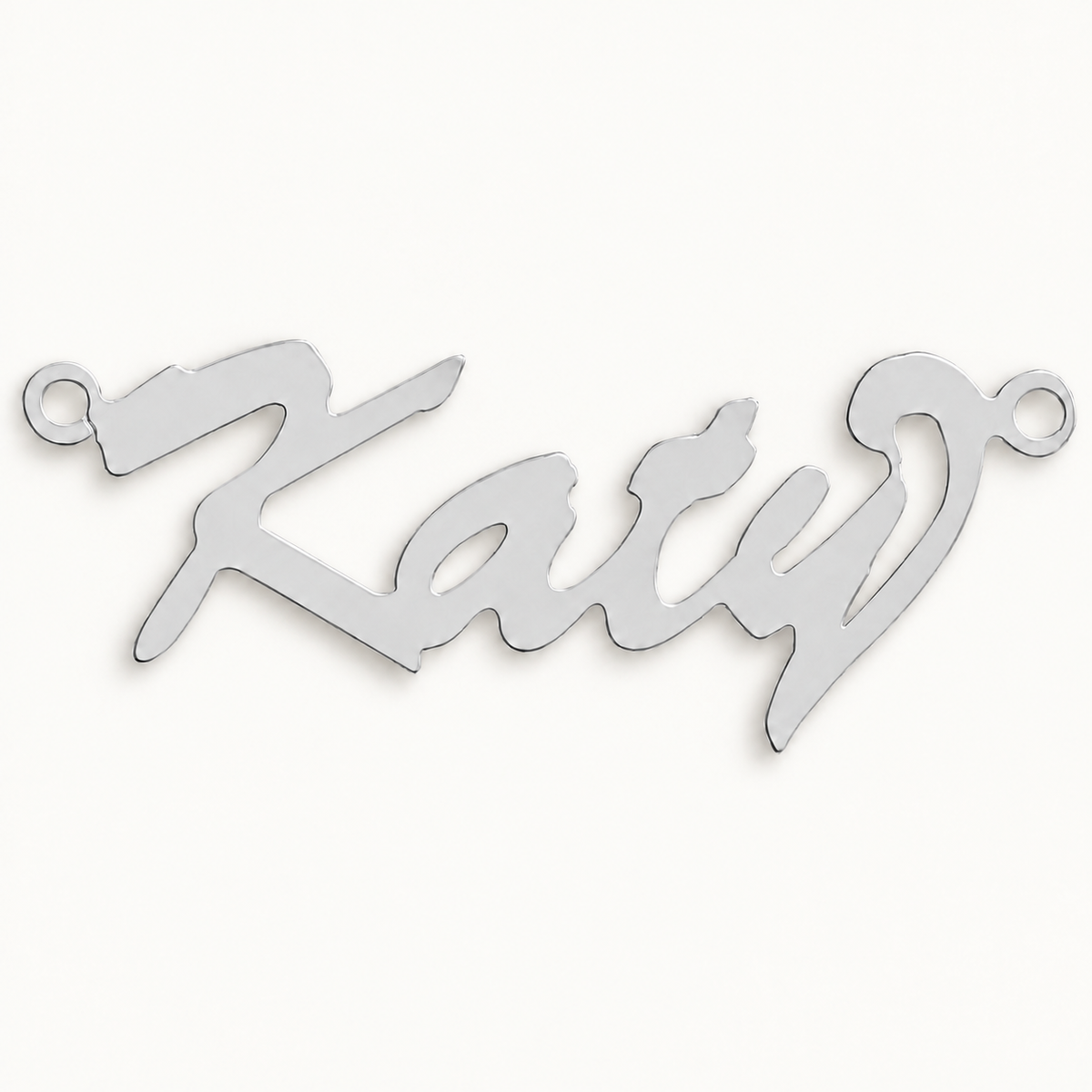 Sterling silver Script Curl personalised nameplate, example Katie, illustrative image on pale off-white background
