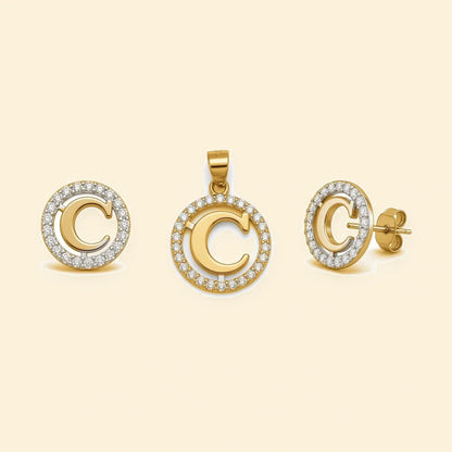 Gold plated sterling silver CZ initial C pendant set on ivory background