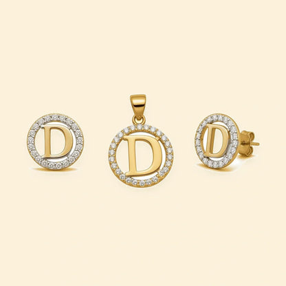 Gold plated sterling silver CZ initial D pendant set on ivory background
