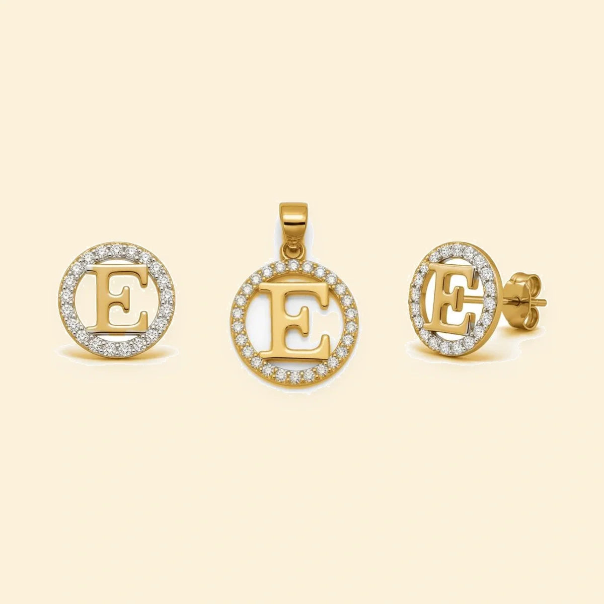 Gold plated sterling silver CZ initial E pendant set on ivory background