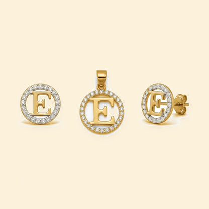 Gold plated sterling silver CZ initial E pendant set on ivory background