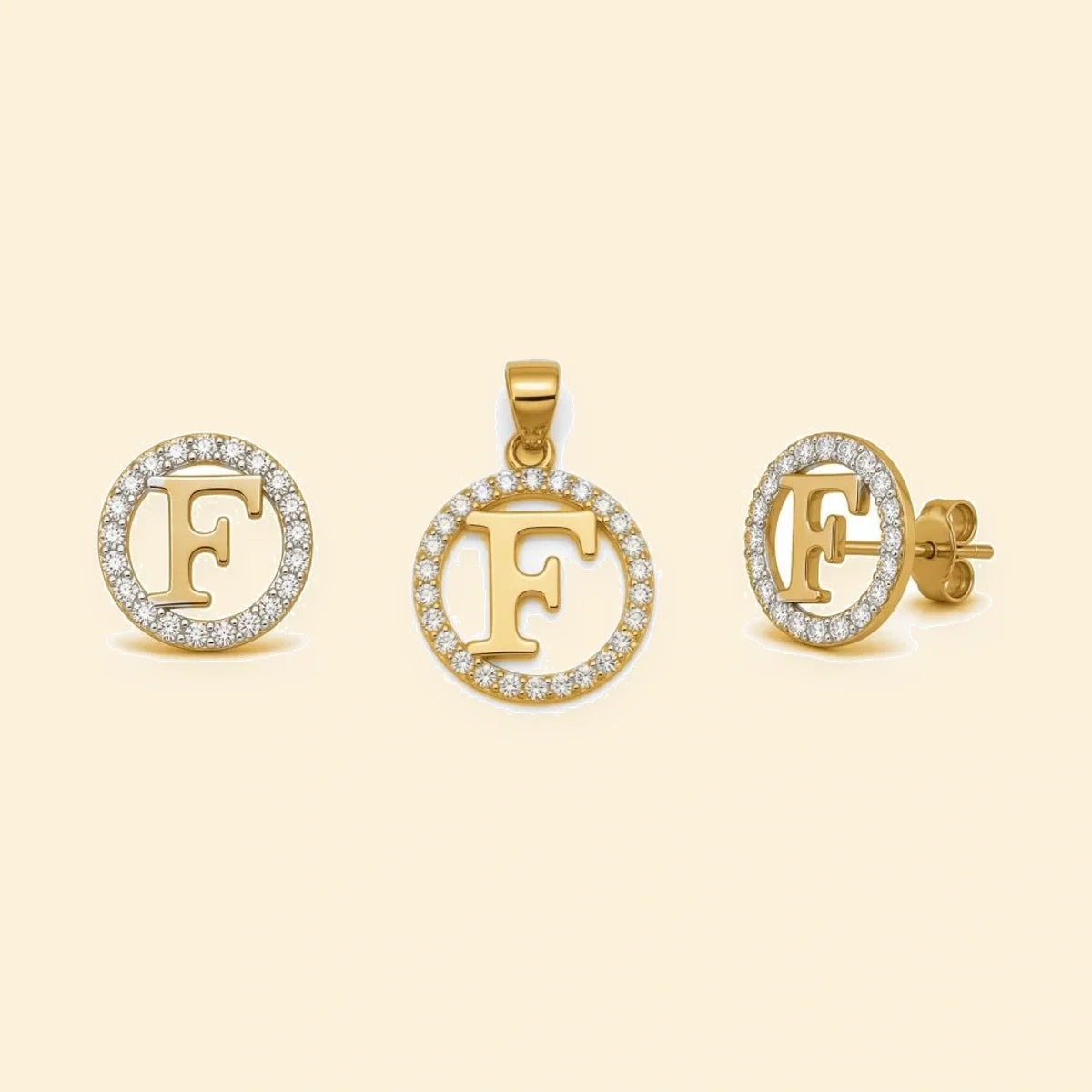 Gold plated sterling silver CZ initial F pendant set on ivory background