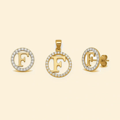Gold plated sterling silver CZ initial F pendant set on ivory background
