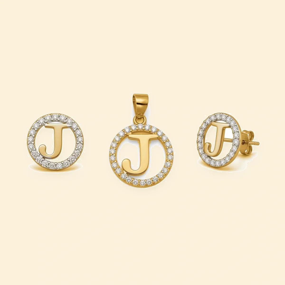 Gold plated sterling silver CZ initial J pendant set on ivory background