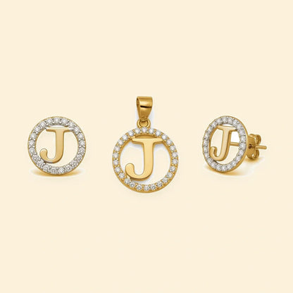 Gold plated sterling silver CZ initial J pendant set on ivory background