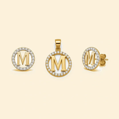 Gold plated sterling silver CZ initial M pendant set on ivory background