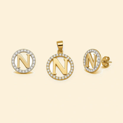 Gold plated sterling silver CZ initial N pendant set on ivory background