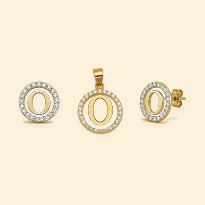 Gold plated sterling silver CZ initial O pendant set on ivory background