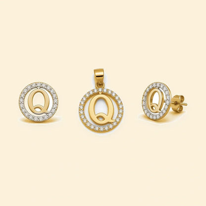 Gold plated sterling silver CZ initial Q pendant set on ivory background