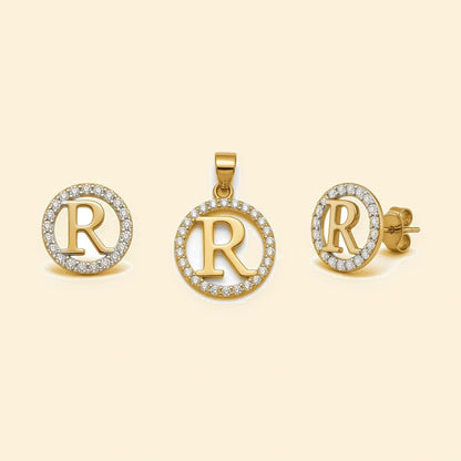 Gold plated sterling silver CZ initial R pendant set on ivory background