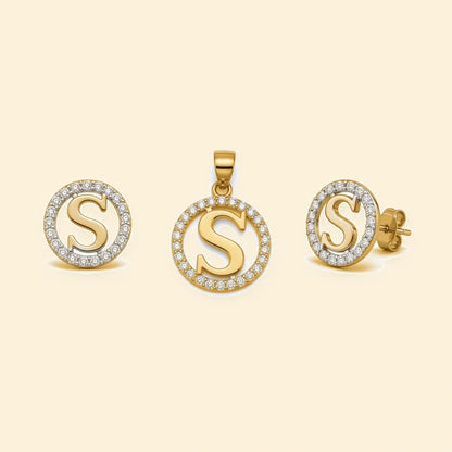 Gold plated sterling silver CZ initial S pendant set on ivory background