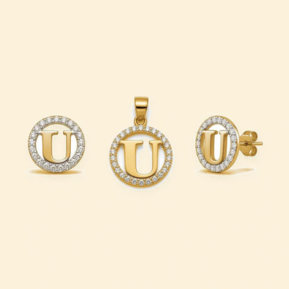 Gold plated sterling silver CZ initial U pendant set on ivory background