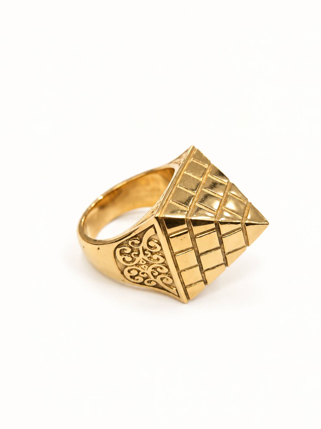 Men's gold geometric signet ring with engraved shoulder, side view on pale ivory