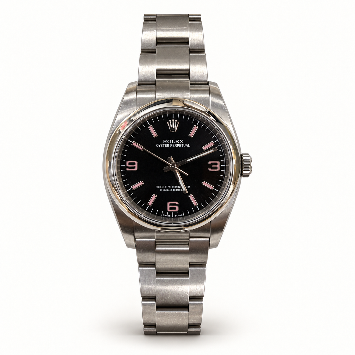 Pre-owned Rolex Oyster Perpetual 116000 Pink Explorer from 2016, with black dial, pink 3-6-9 numerals and stainless steel Oyster bracelet on ivory background